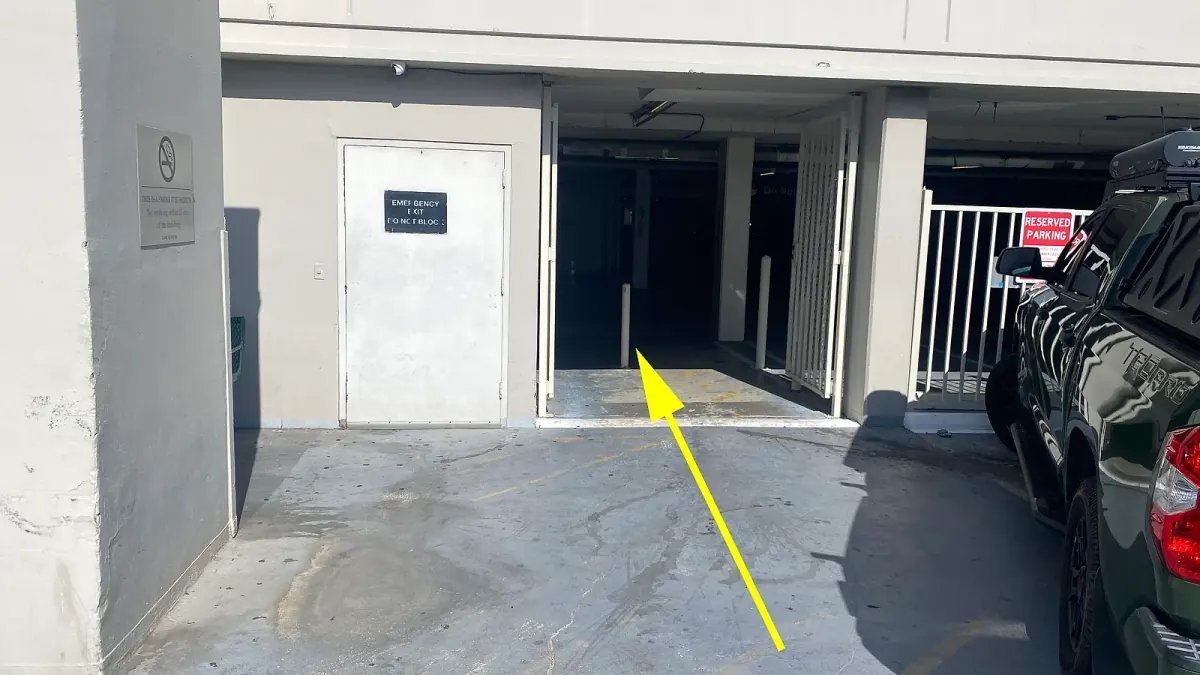 Walking from the side parking area toward the indoor entrance